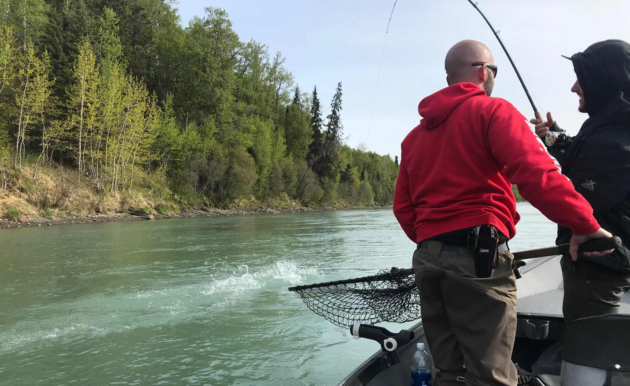RiverRise Fishing Guides netting a Salmon for one of their clients on the Kasilof River.